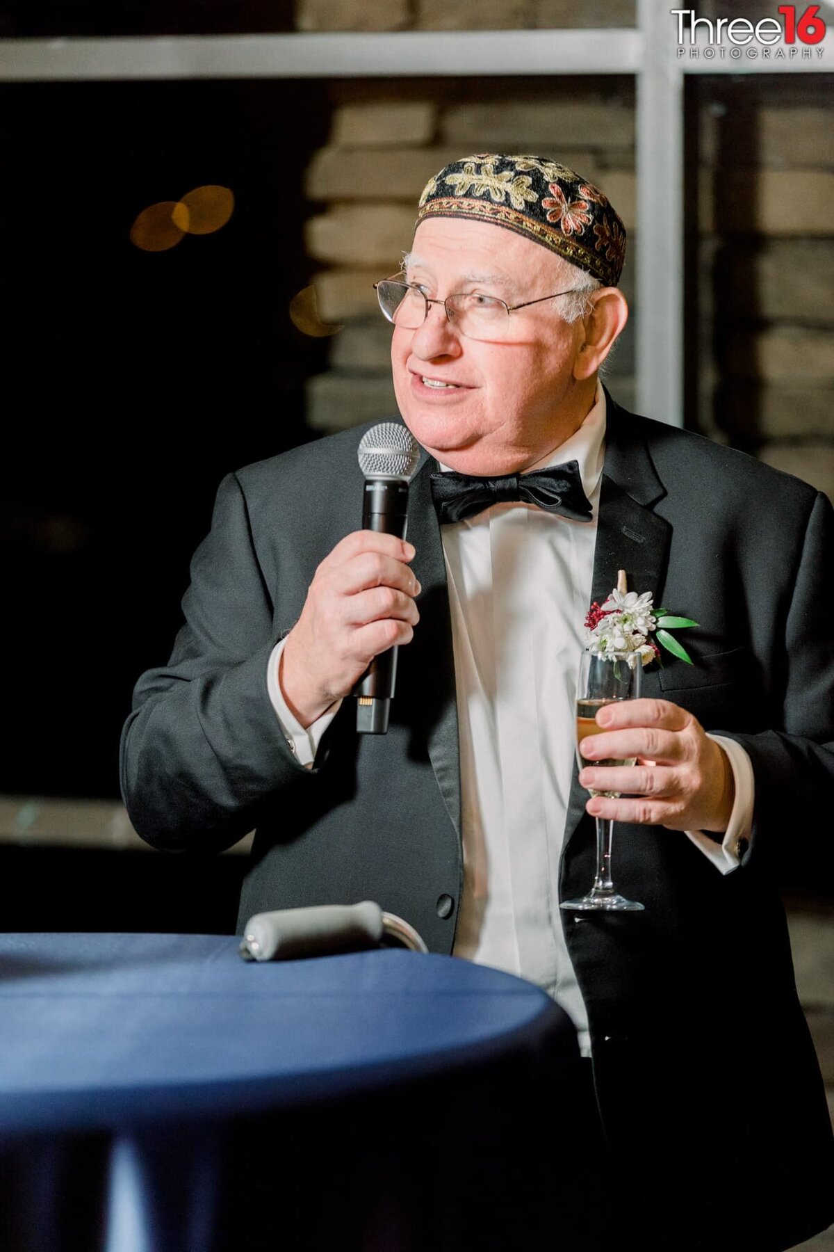 Father lifts his glass as he toasts the newly married couple