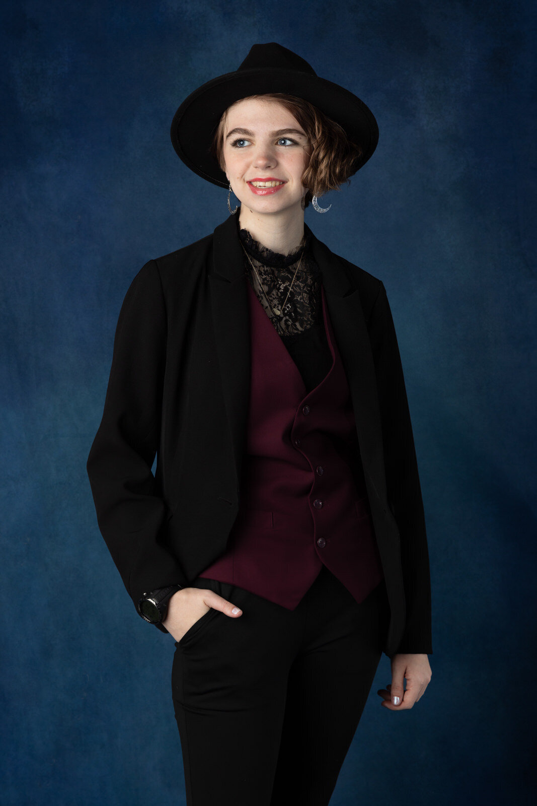 senior-girl-in-suit-and-moon-earing-and-fedora