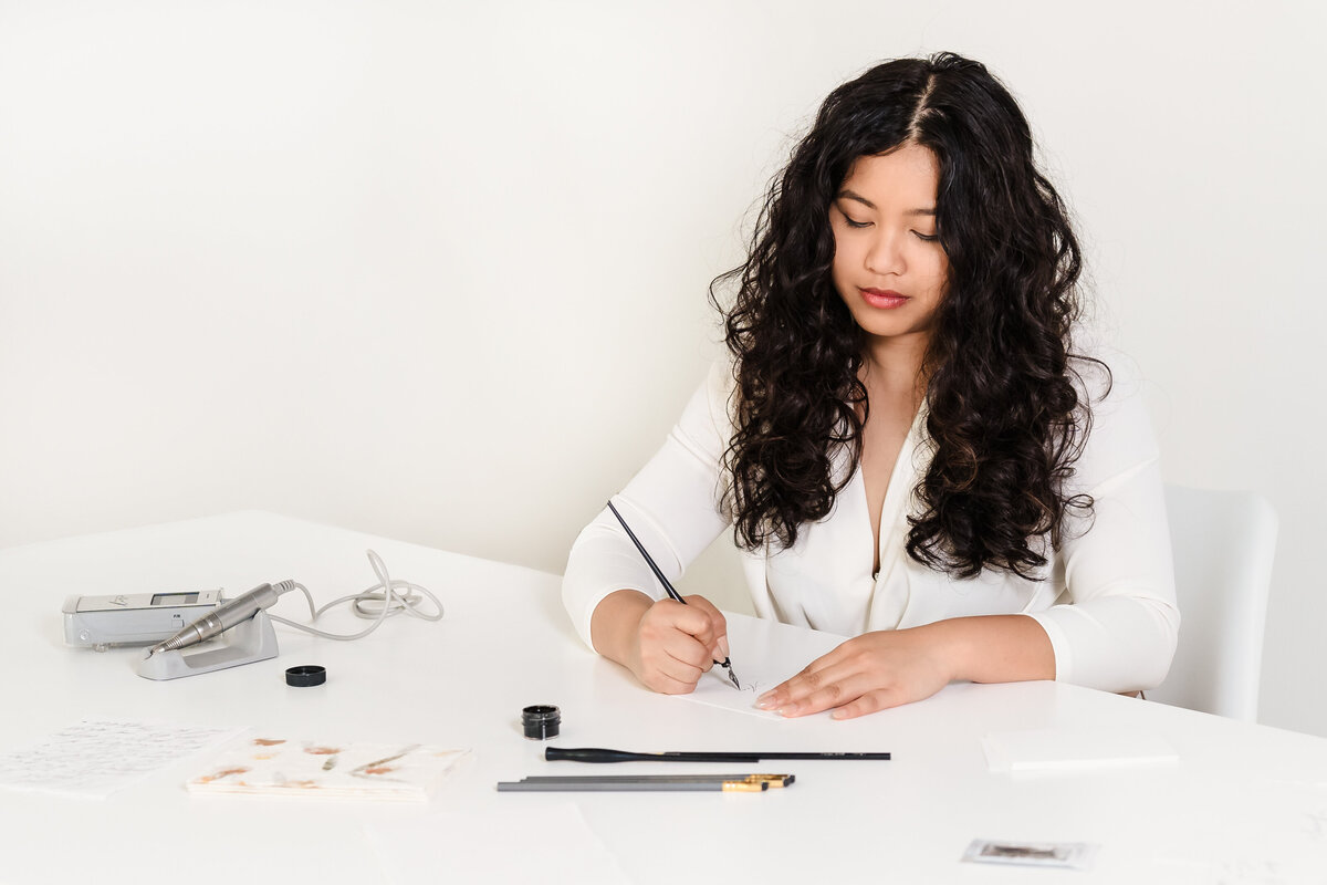 brand photo of a calligrapher doing her craft