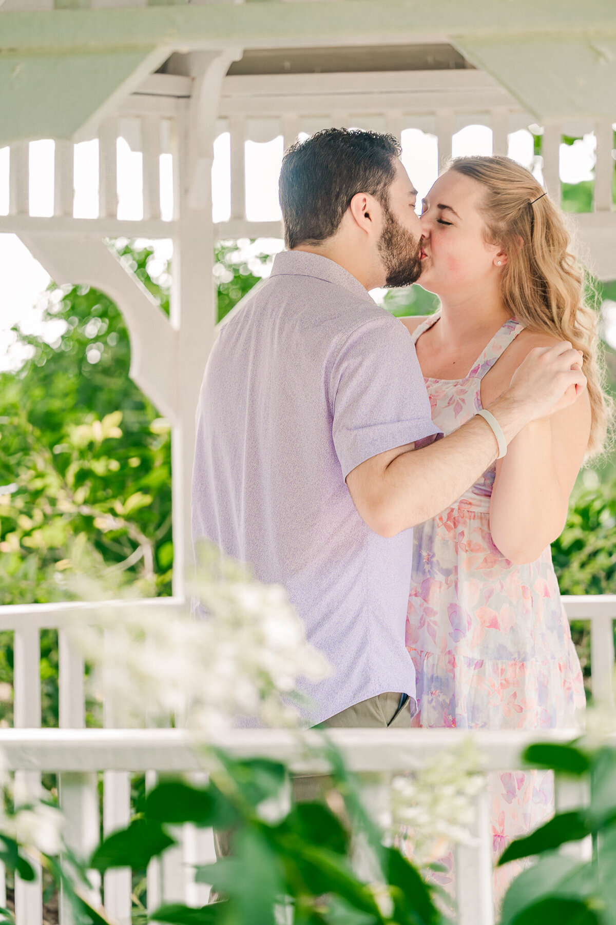 Kisses in a gazebo at Airlie Gardens by a happy couple enjoying their Wilmington wedding photos by JoLynn Photography