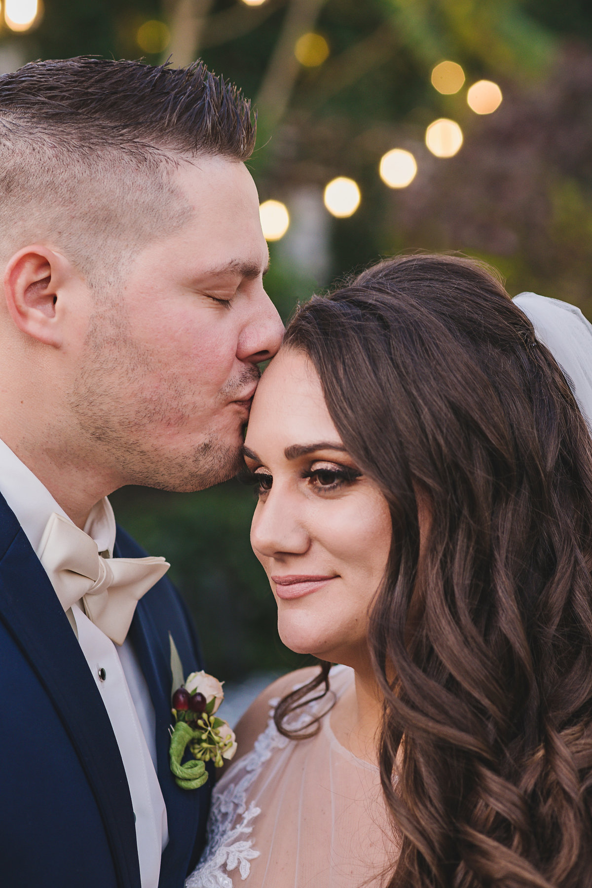 groom kissing brides forehead at Fox Hollow wedding
