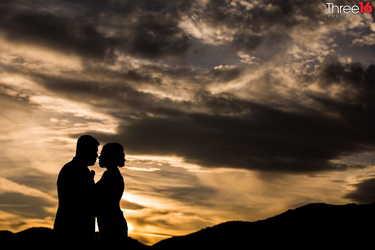 Beautiful sunset and silhouette photo of the Bride and Groom