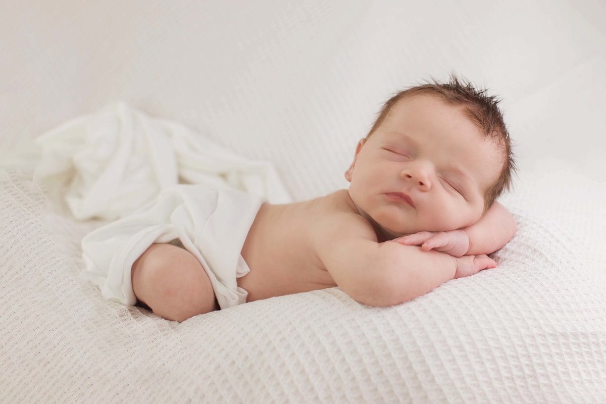 baby posed on a white backdrop in-home posed newborn photos Cincinnati