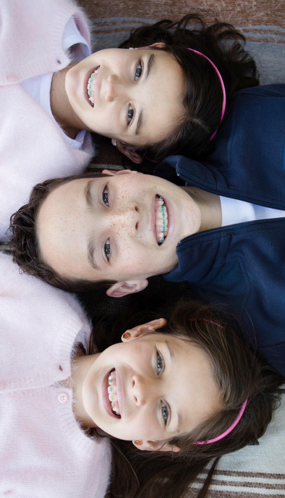 Three Kids smiling family portraits