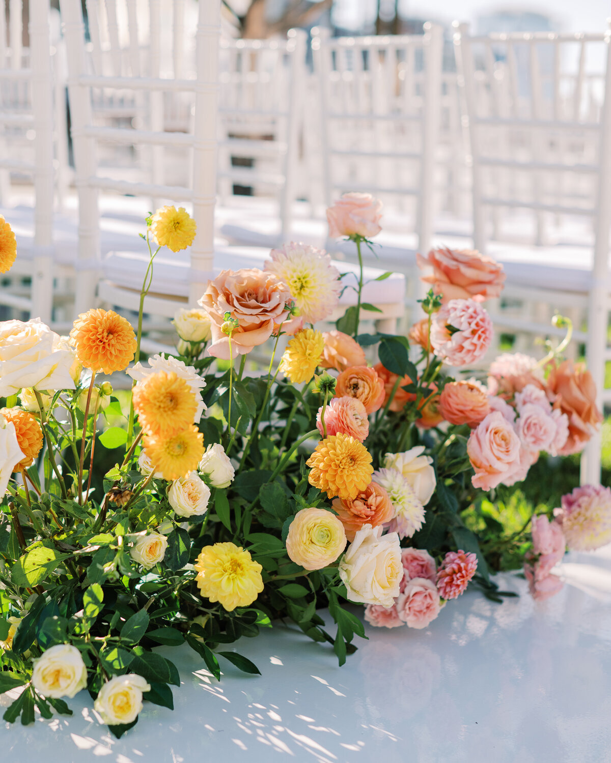Yellow, peach, apricot, tangerine, pink, blush wedding ceremony flowers