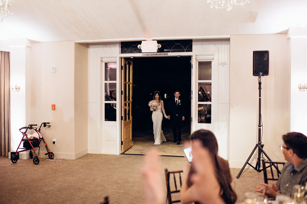 Wedding Photograph Of Man And Woman Entering  The Reception Hall Los Angeles