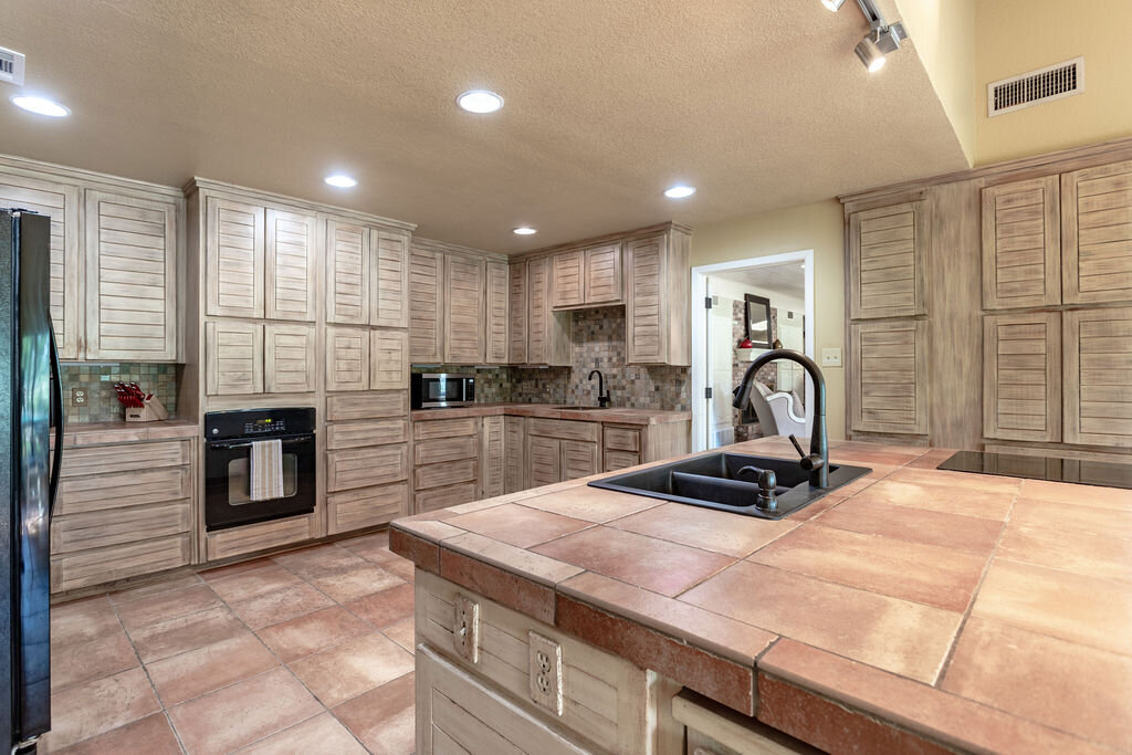 Spacious kitchen with plenty of counter space at this 5-bedroom, 4-bathroom vacation rental house for 16+ guests with pool, free wifi, guesthouse and game room just 20 minutes away from downtown Waco, TX.