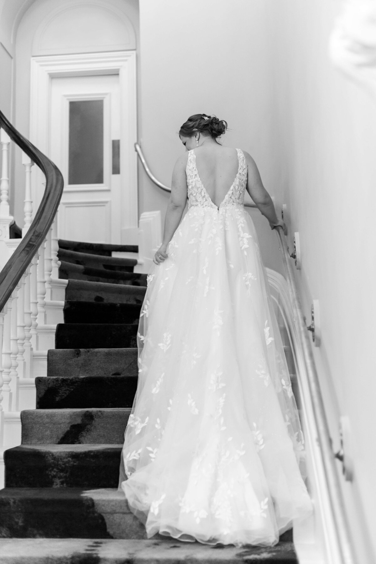 Bride walking up stairs at  at Halifax Club wedding in Nova Scotia