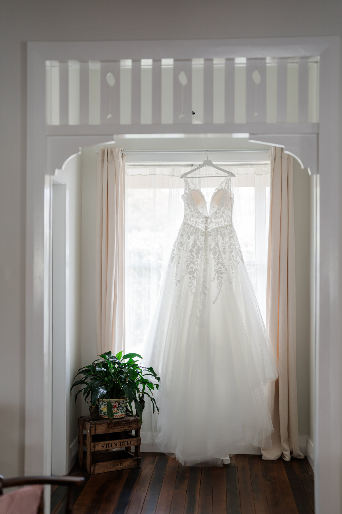 Wedding dress hangning in a window