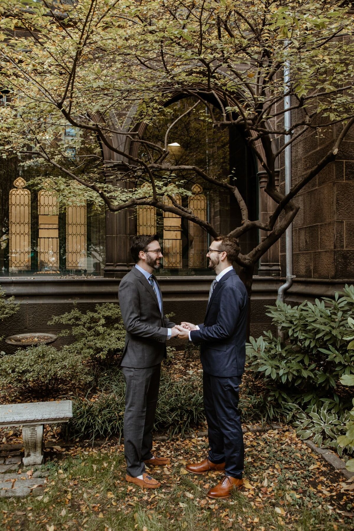 grooms holding hands during ceremony