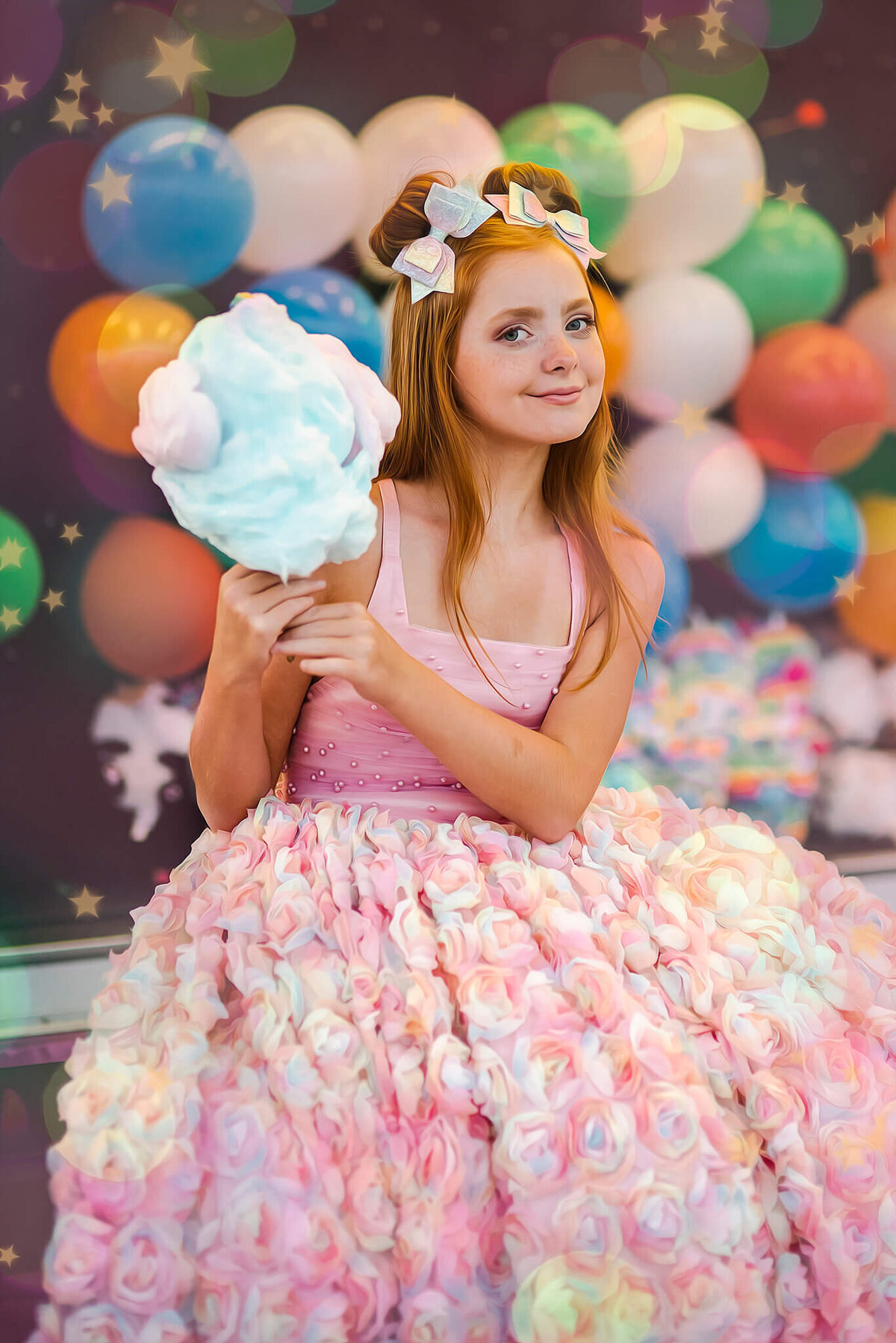 red haired girl sitting and eating cotton candy in front of balloons at a carnival near Annapolis Maryland