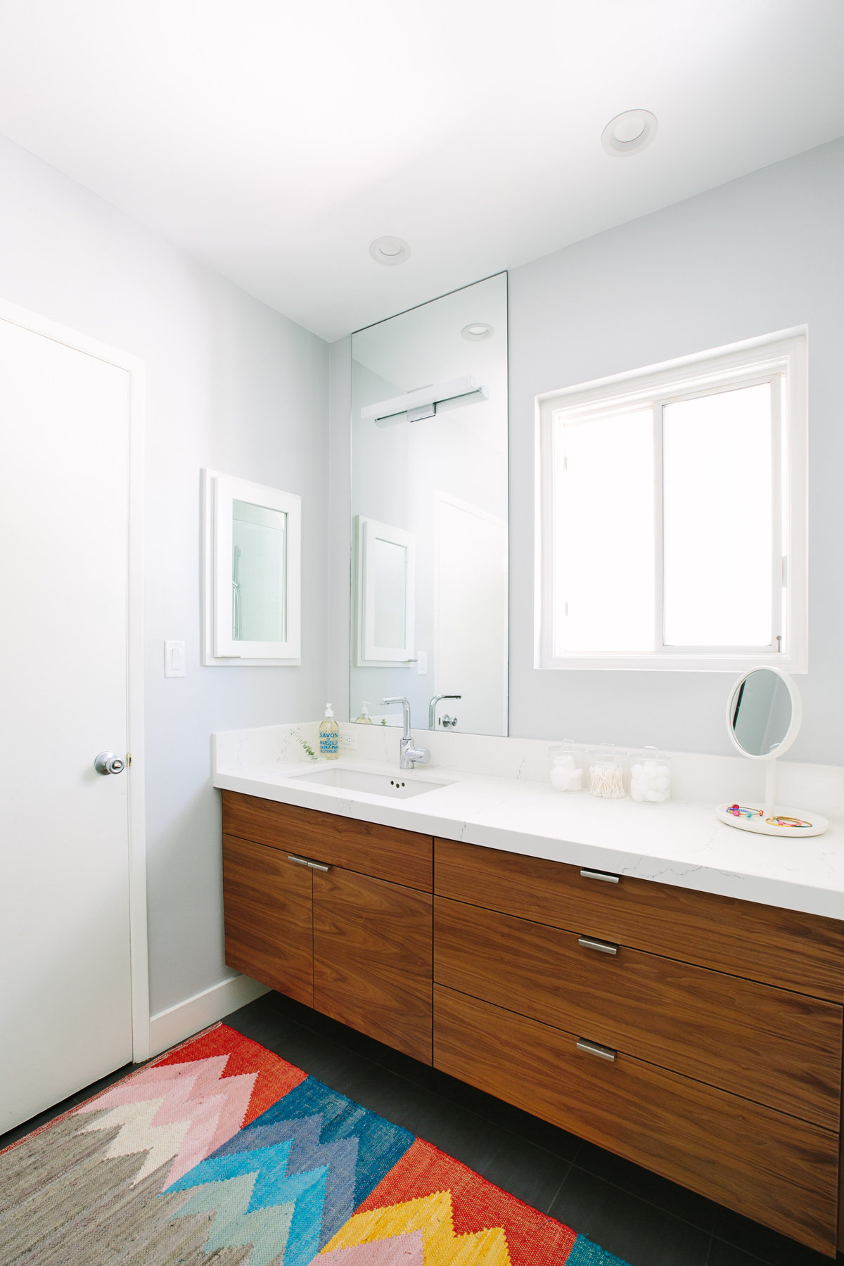 Modern bathroom with floating walnut vanity