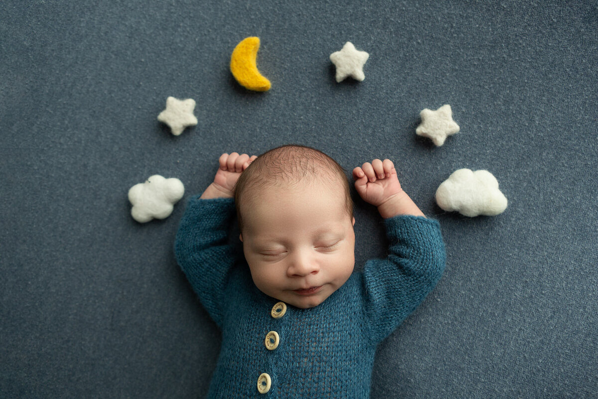 columbus-ohio-newborn-baby-boy-in-denim-blue-knit-romper-in-relaxed -pose