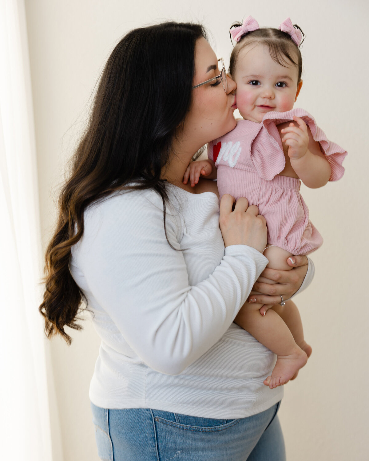 A kiss full of love to celebrate one sweet year. Captured by Yucaipa cake smash photographer Kaitlyn Dawn Photography, this moment between mama and her birthday girl is pure magic.
