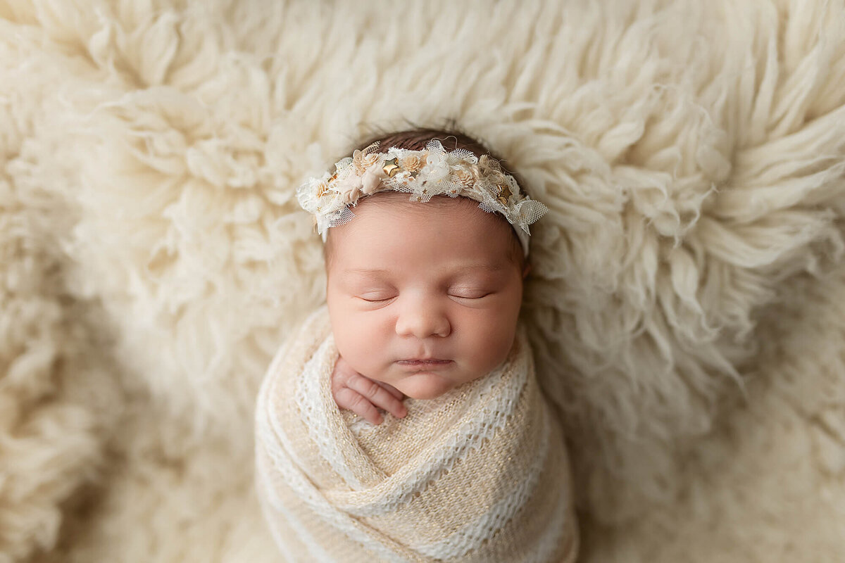 Baby girl wearing a delicate headband during her session.