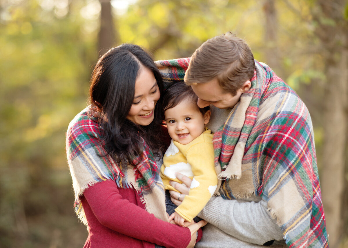 Family session of little boy and his parents located outside