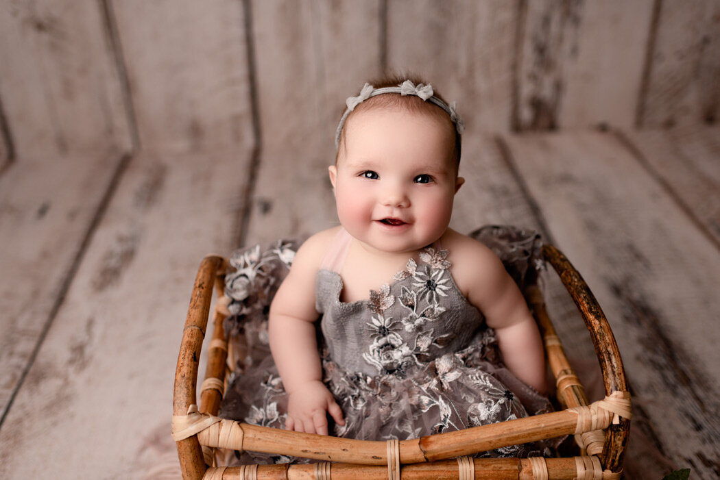 Brighton Newborn Photographer on year milestone in basket by For The Love Of Photography