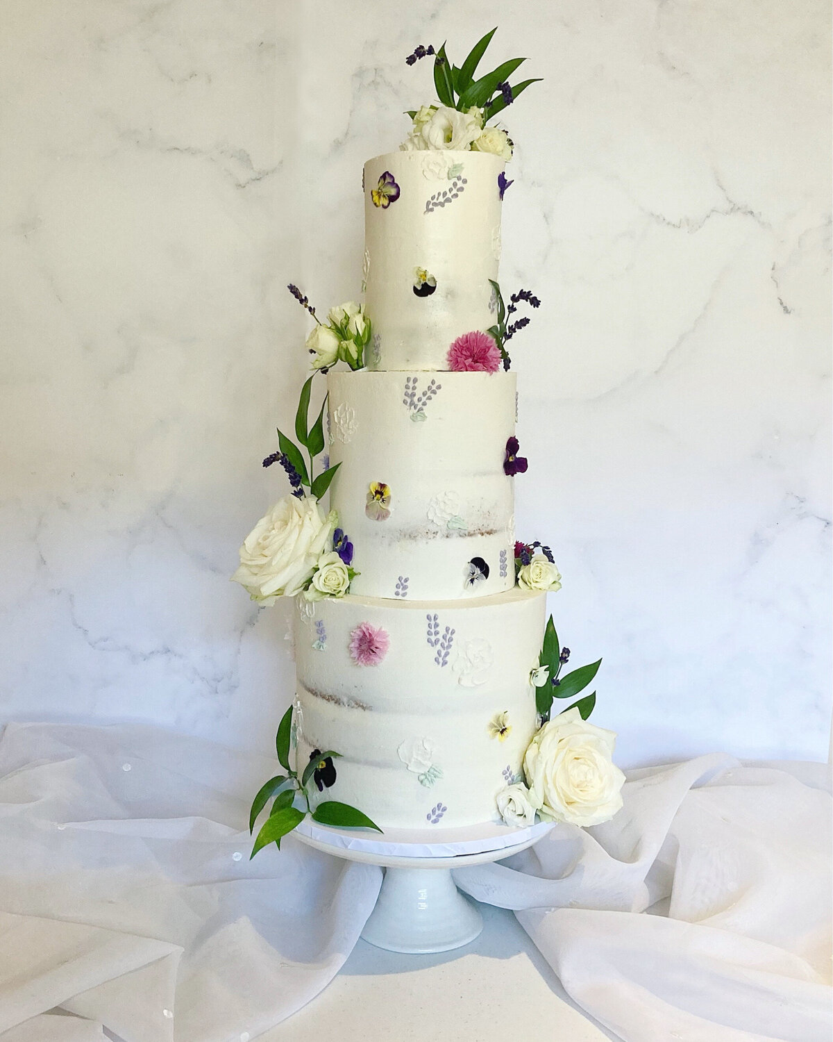 Semi-naked edible flower and hand piped buttercream wedding cake inspired by English country garden