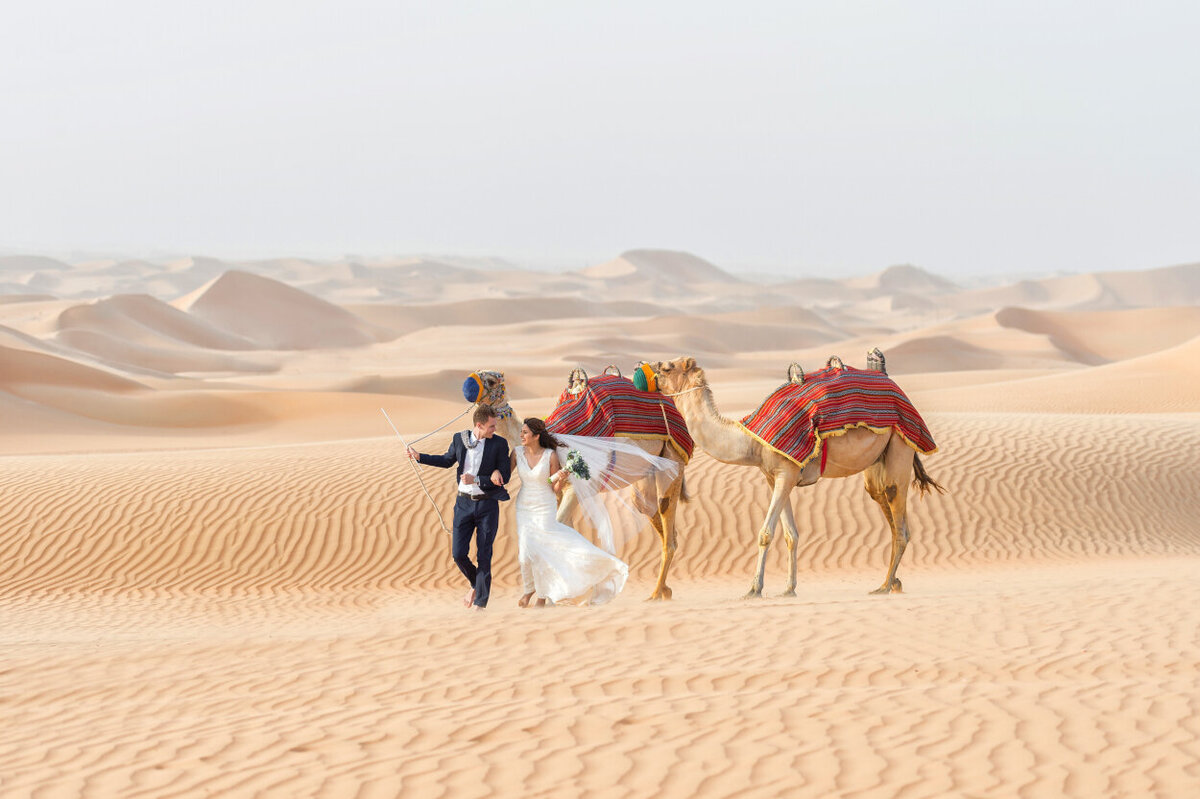 Dubai wedding photoshoot amidst desert dunes with camels organized by Lovely & Planned