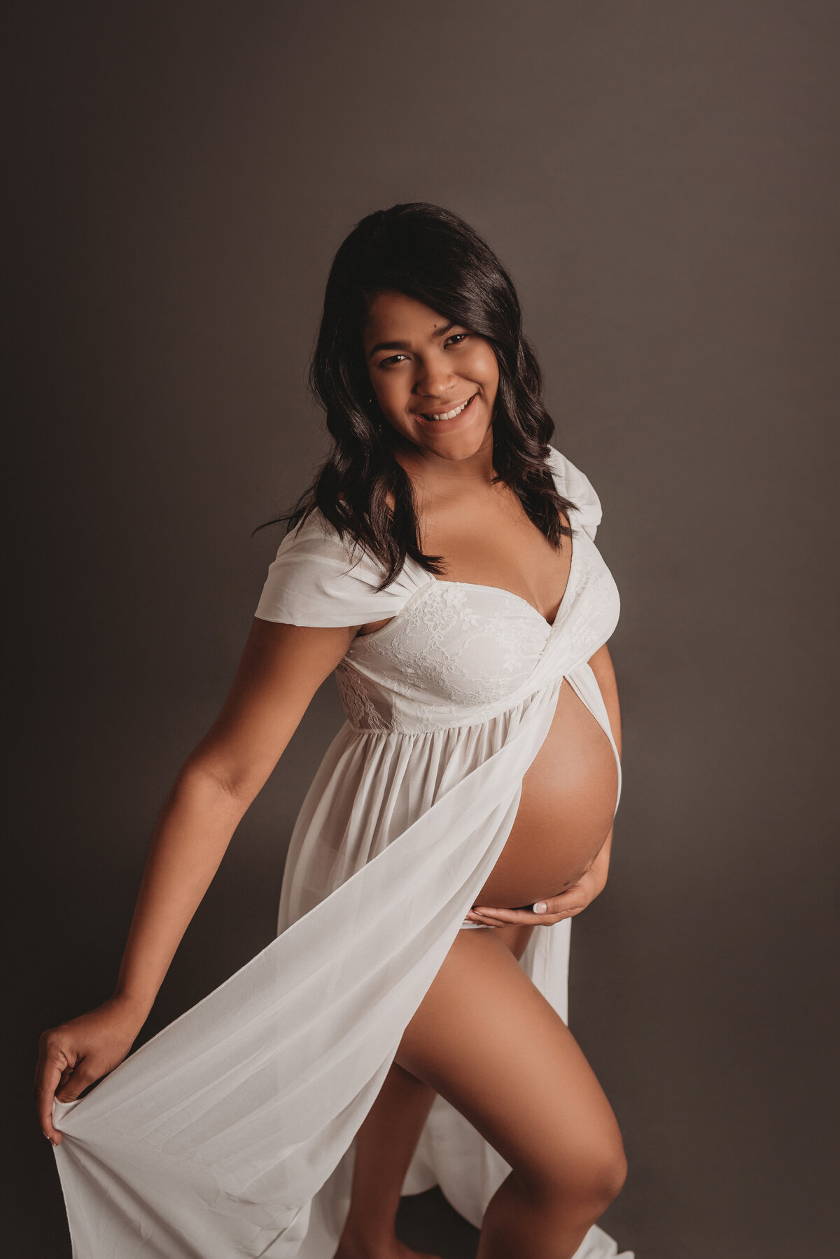Pregnant woman wearing white sheer dress