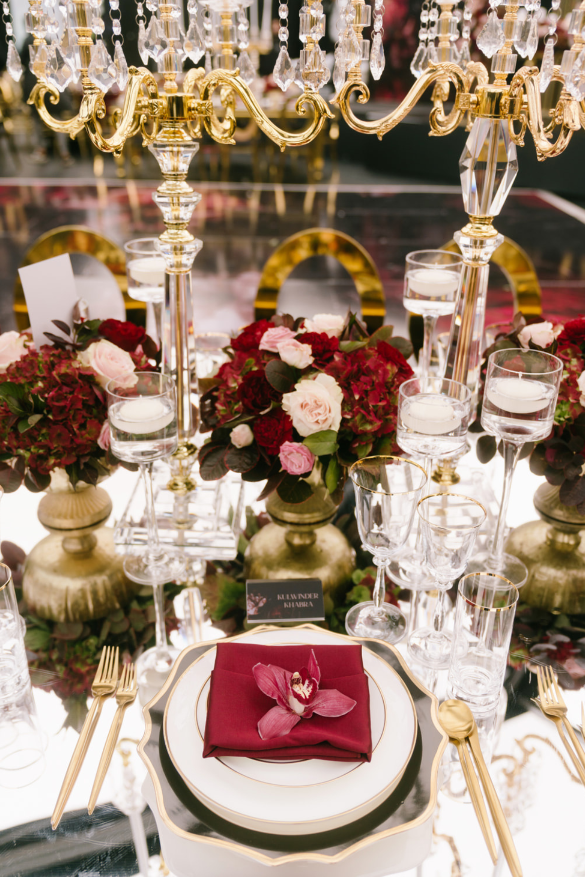 black-gold-burgundy-red-tent-reception-candelabra-napkin-orchid-place-setting
