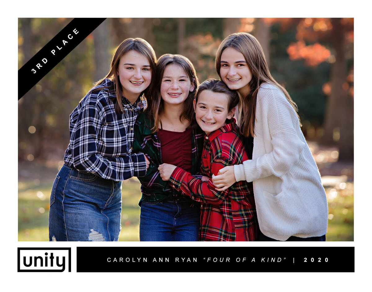 Portrait of four young ladies squeezing together for a group hug wearing cute plaid shirts and skirts or dresses. Words on a small banner in the left corner says "3RD Place" The bottom says "UNITY and says Carolyn Ann Ryan, "Four of a Kind" | 2020