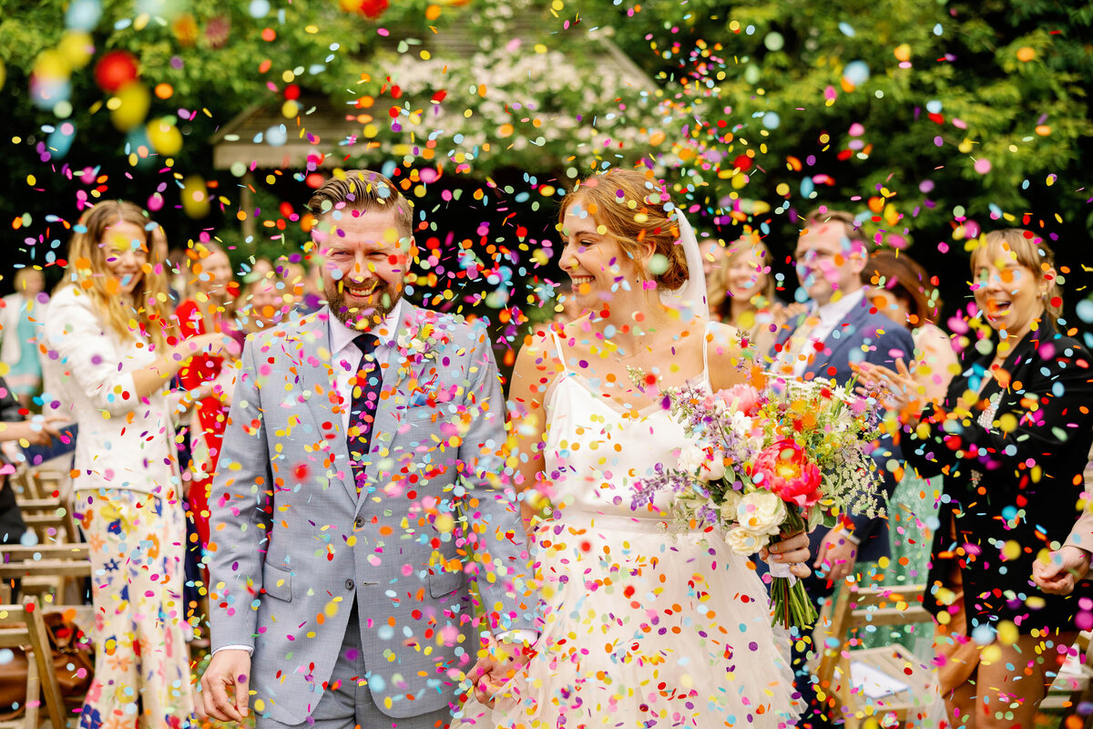 Bride and groom showered in colourful confetti at Pennard House