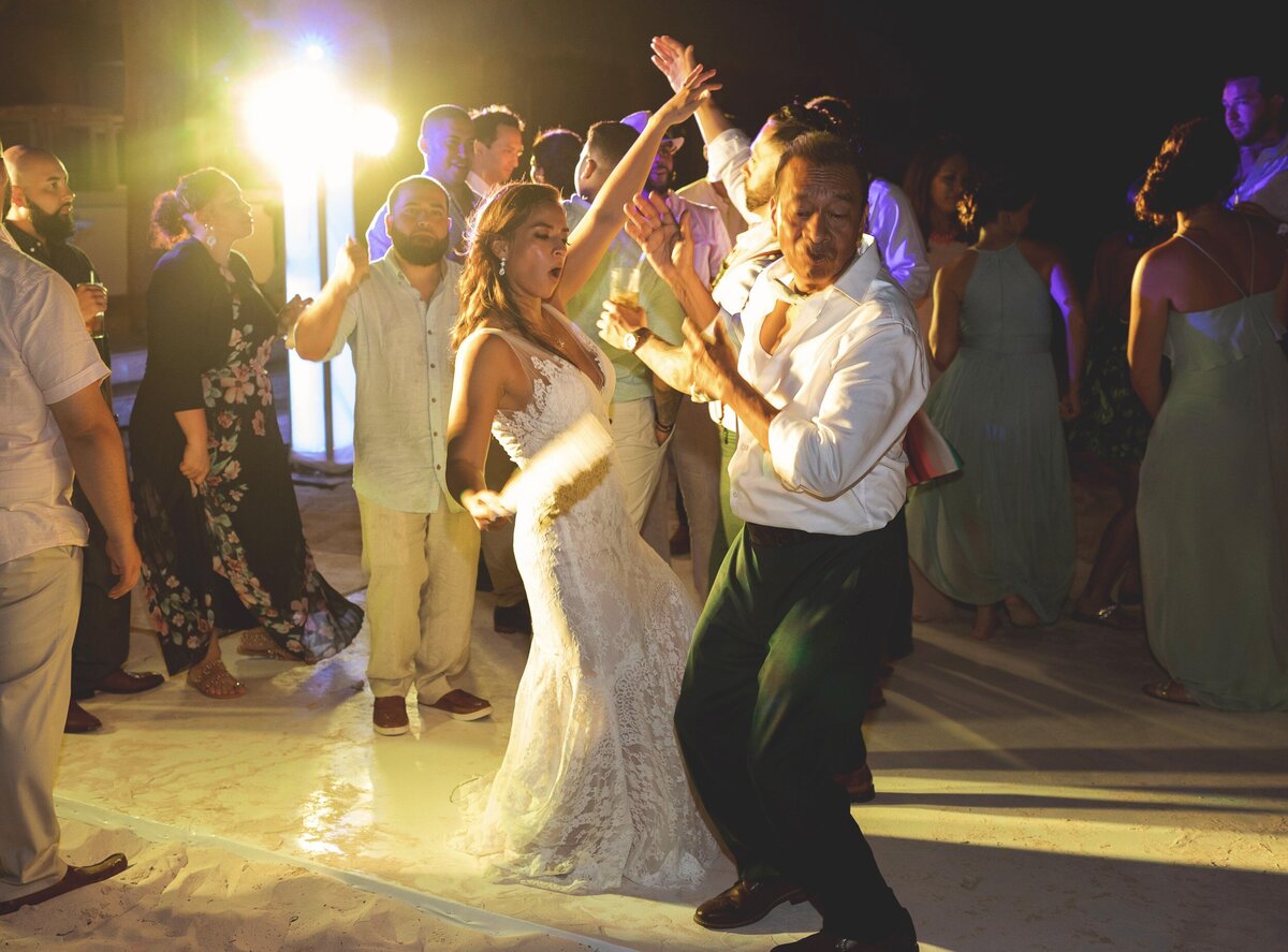 Bride dancing with father at wedding reception in Cancun