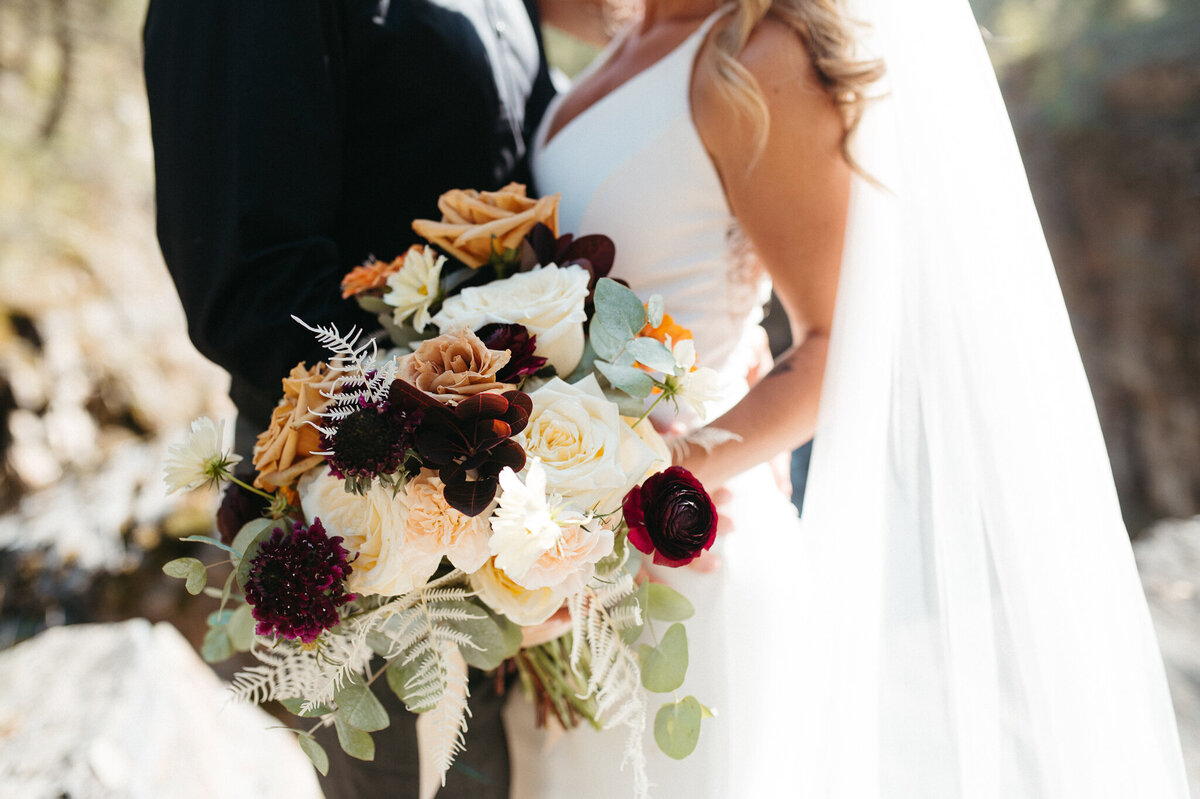 Burgundy, rust and tangerine, fall-inspired bridal bouquet by The Romantiks, romantic wedding florals based in Calgary, AB & Cranbrook, BC. Featured on the Brontë Bride Vendor Guide.