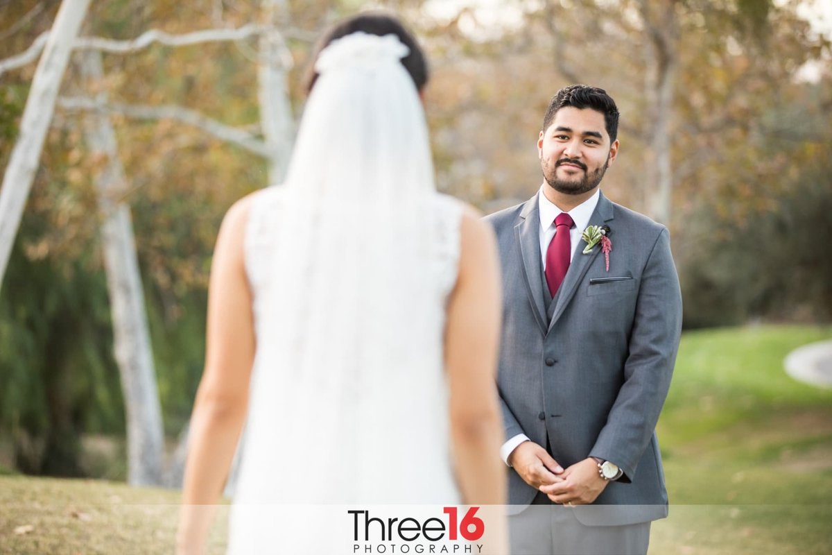 Groom stares at his Bride as he sees her for the first time in a First Look Photo Session