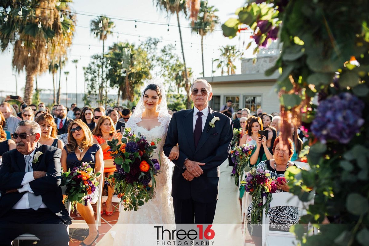 Father of the Bride escorts his daughter to the altar