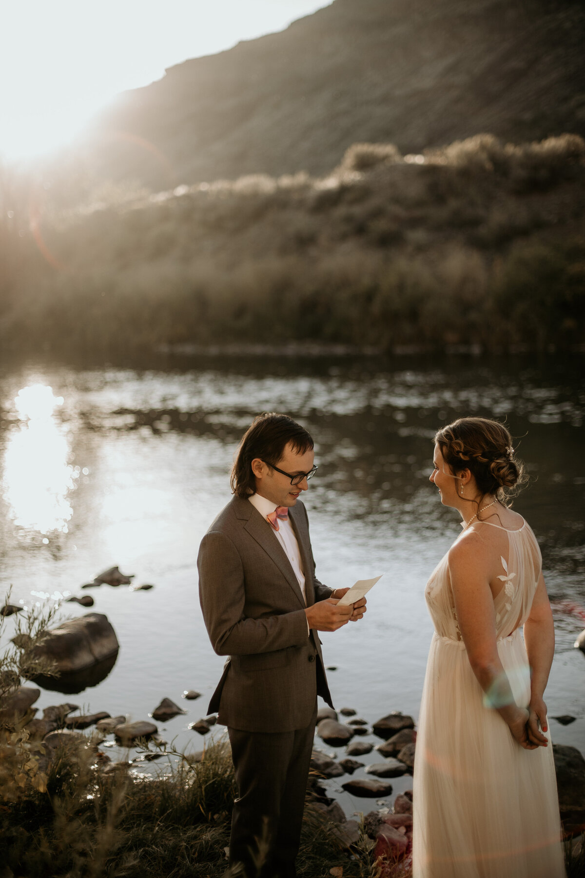 groom saying his vows by a river