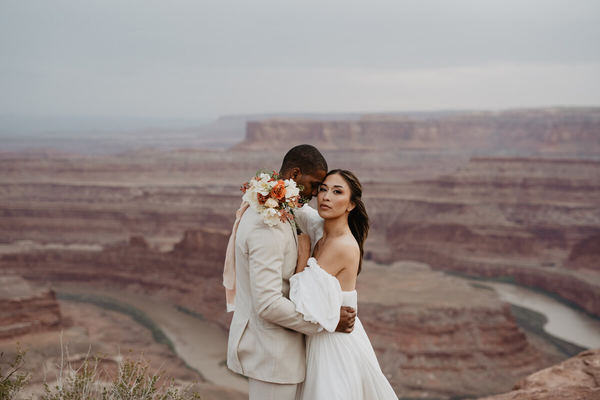 Utah Elopement Photographer captures couple hugging after Moab Wedding
