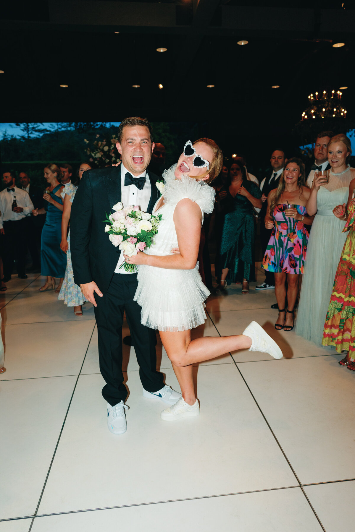 The party begins at summer destination wedding reception at the Farm at Old Edwards. All white dance floor and live band. Destination wedding photographer. Kailee DiMeglio Photography.