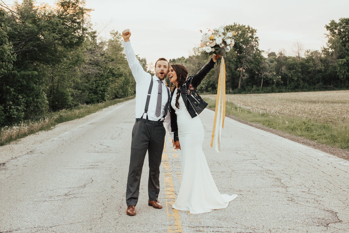 Bride and groom standing on the road celebrating their marriage