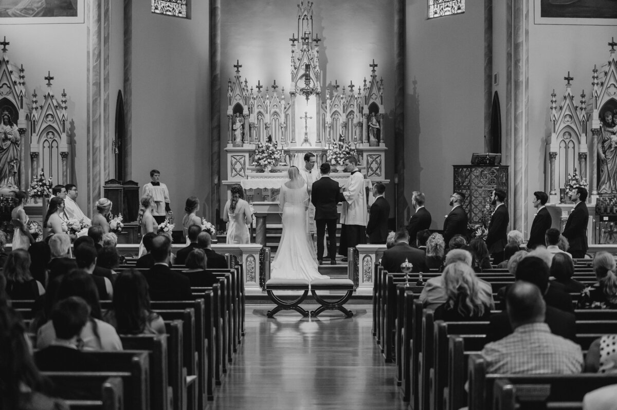 a bride and groom standing at a church altar