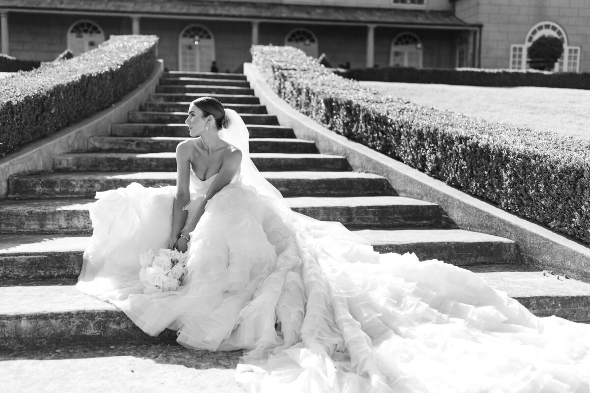 Bride in long dress on the steps.