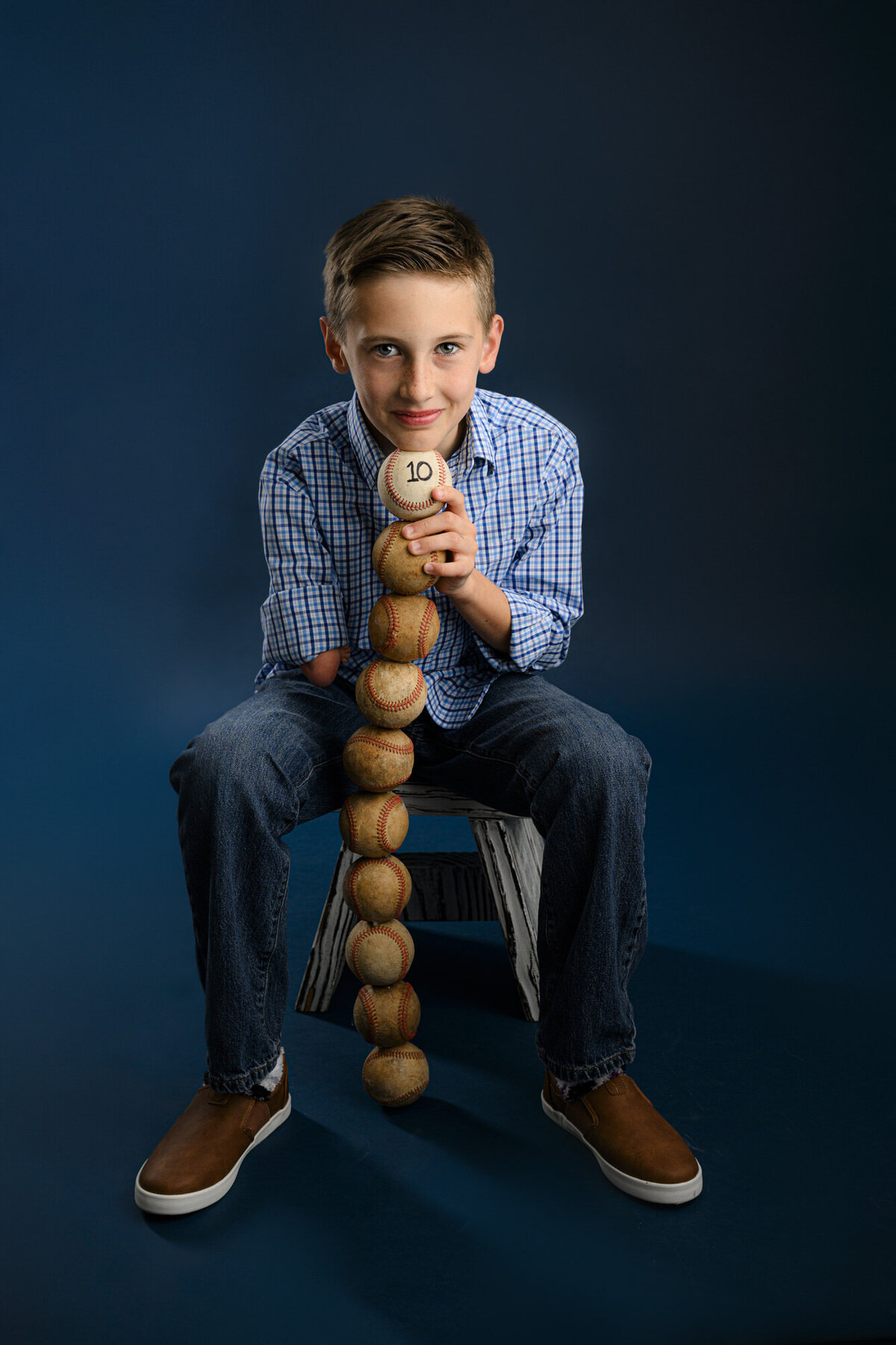 10 year old boy balances baseballs as a non to one of his favorite activities for his 10th birthday milestone