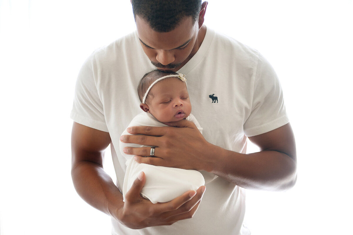 Newborn session of baby girl and father