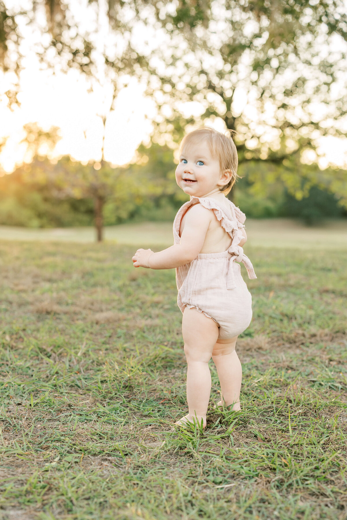 a one year old girl smiling