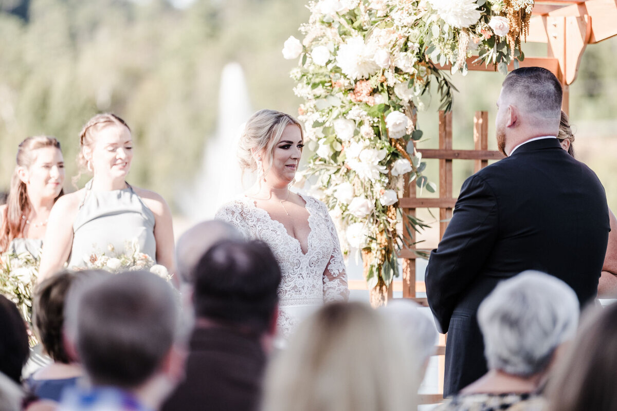 Bride and groom at the altar with ceremony florals