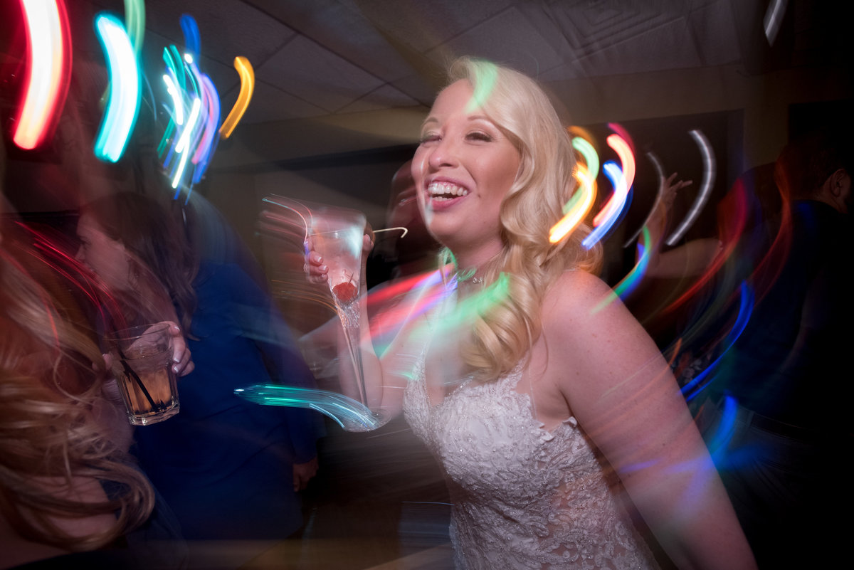 bride dancing with champaign with swirling lights