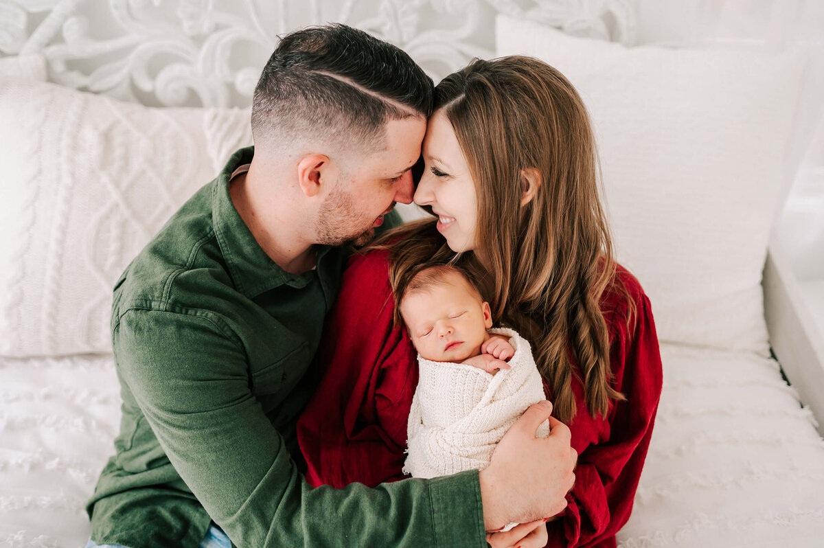 Springfield MO newborn photographer captures parents noes to noes holding sleeping baby