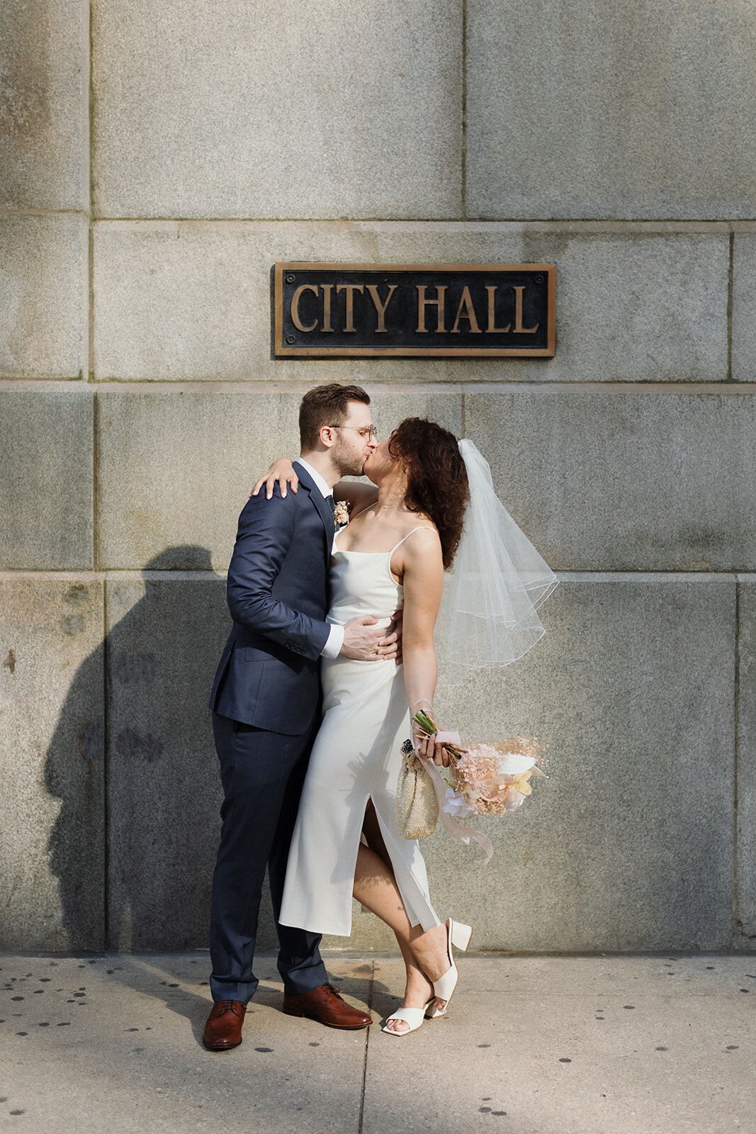 Just Married photo session couple kisses under Chicago City Hall sign