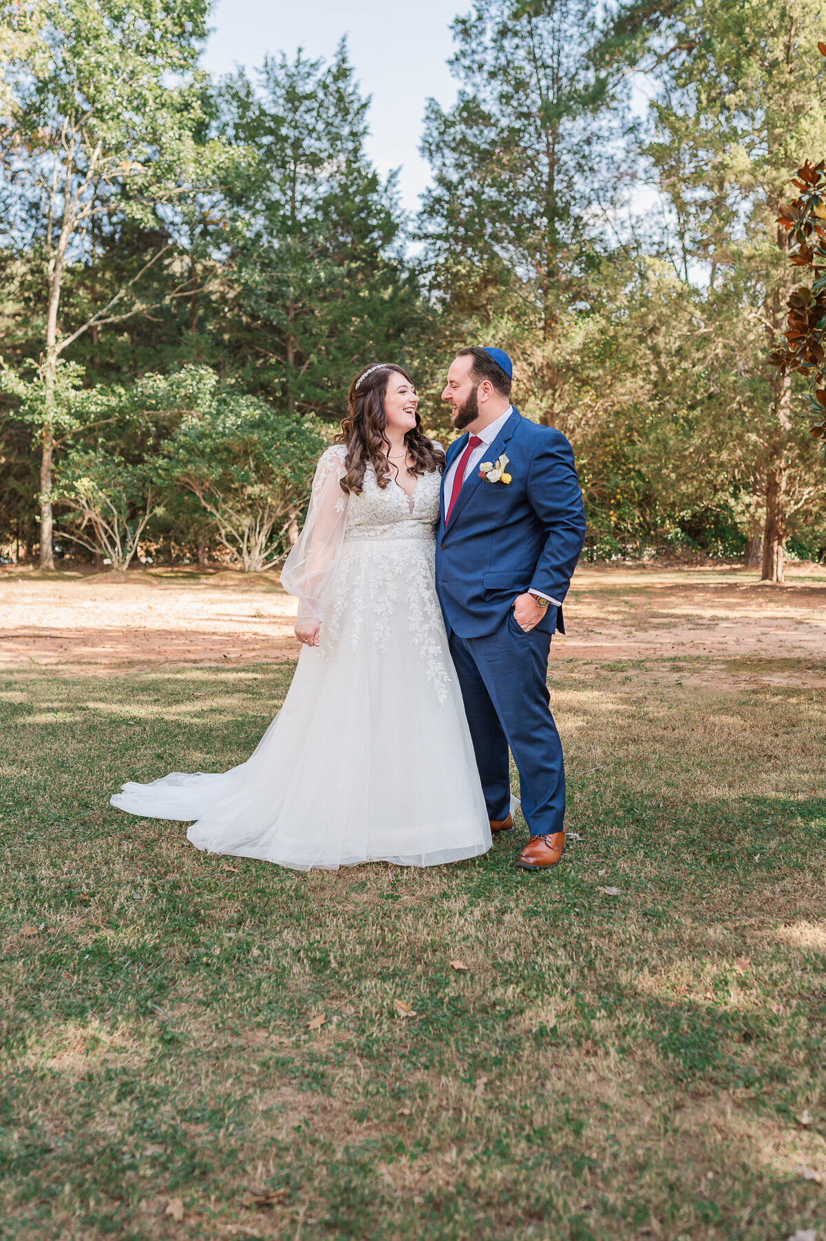 Wedding portraits under the fall leaves at The Sutherland at sunset as the couple enjoys their Raleigh wedding photos