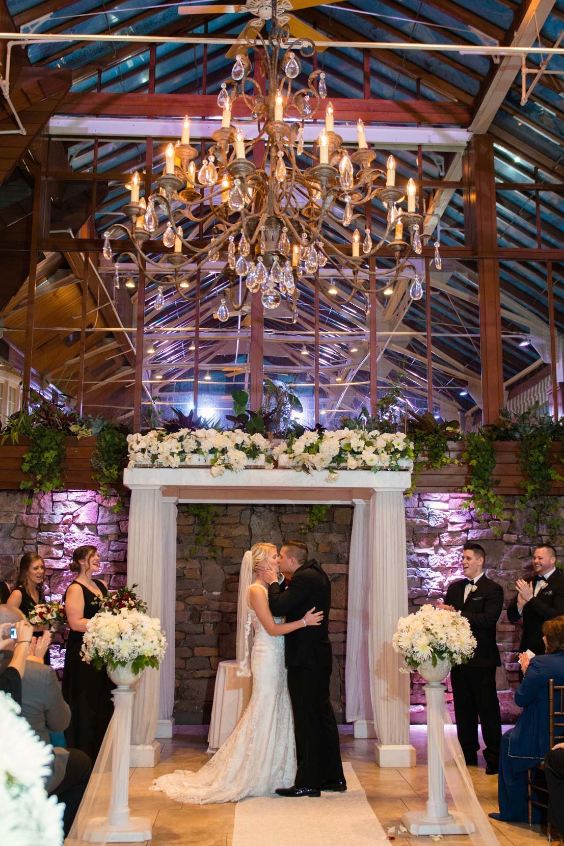 Bride and groom kissing during their ceremony at Fox Hollow