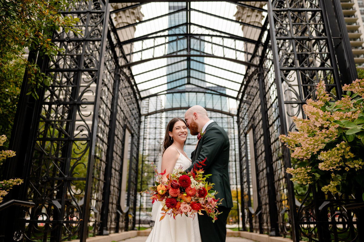 Couple at Maggie Daley Park with fall flowers