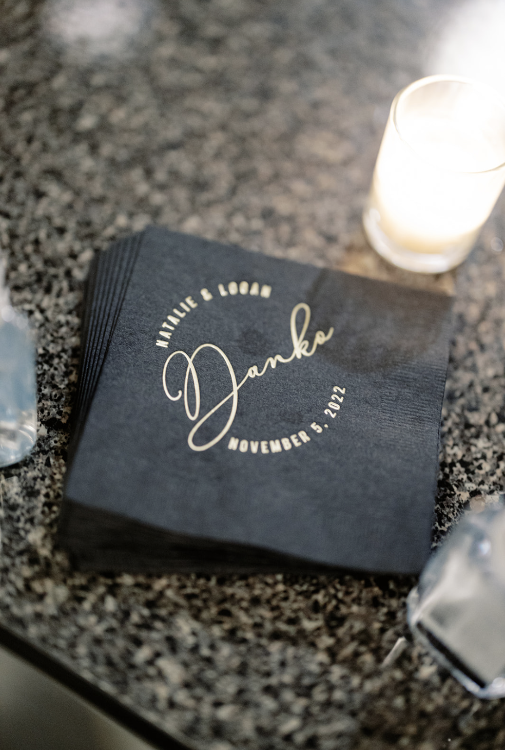 Personalized black napkins with gold foil display name and wedding date at Harold Washington Library reception.