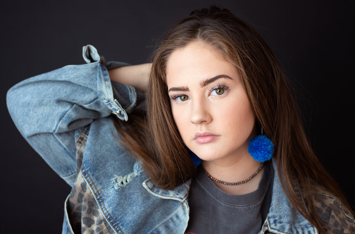 girl wearing a jean jacket for her senior pictures