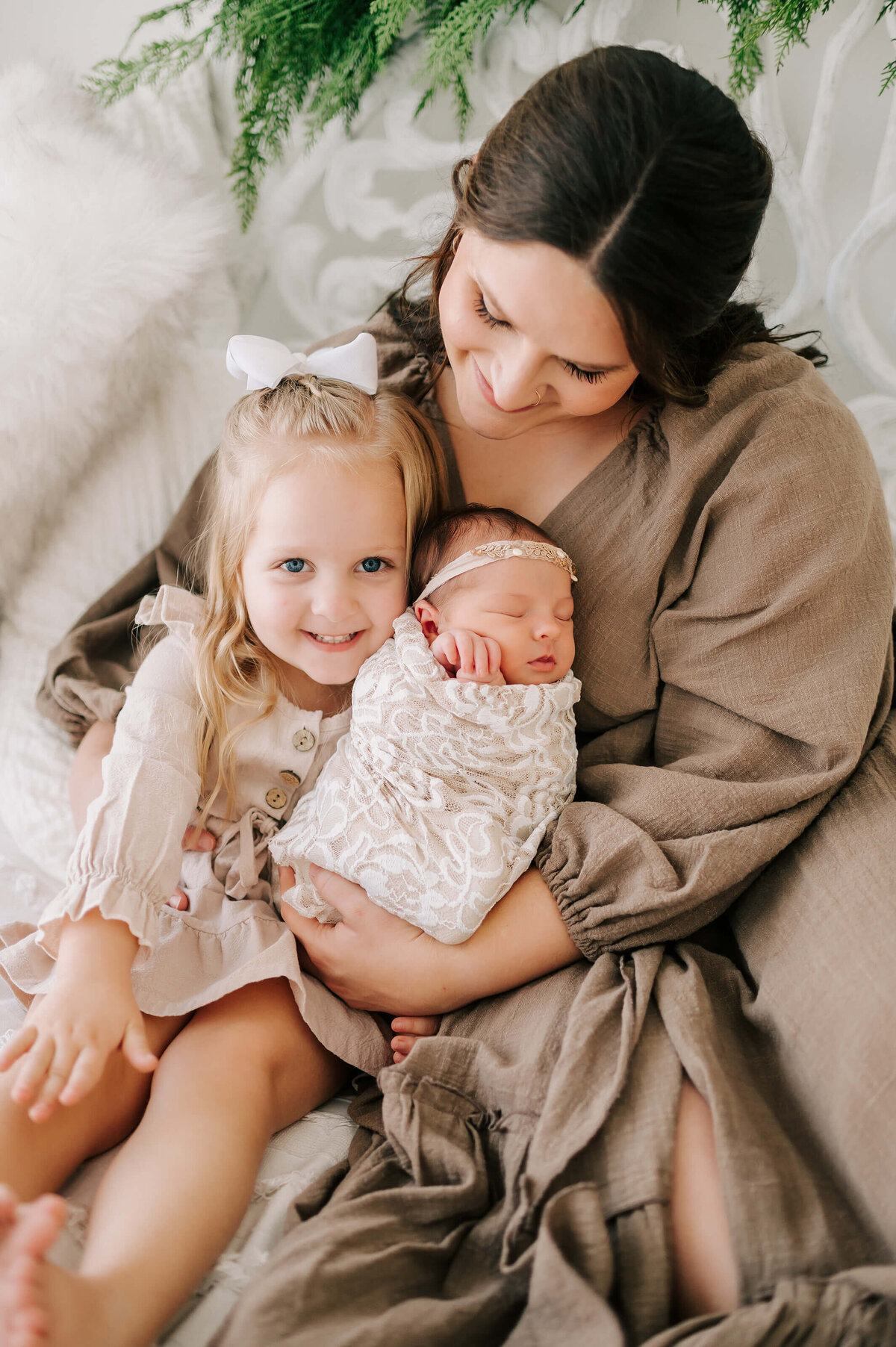 newborn pictures in Springfield MO of mom cuddling her girls